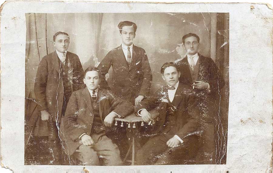 Sepia studio portrait of four young men in suits